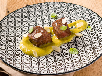Cubes of Wagyu with asparagus, almonds and basil flowers